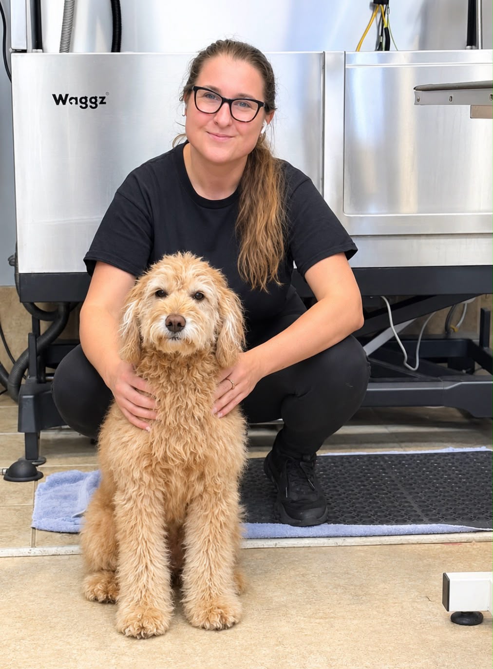 Boston's Groomer team member with a dog in the salon